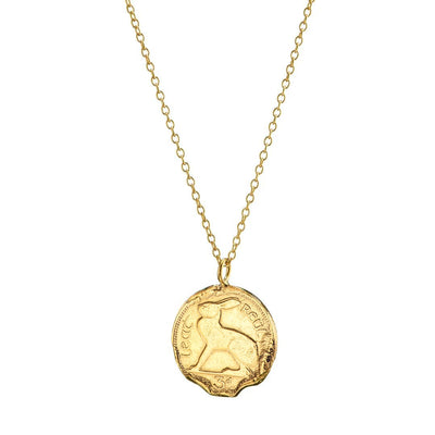 Gold coin necklace by Irish jewellery online store Loinnir Jewellery features a 3 pence coin with a molten wear effect for a unique, relic-like feel.