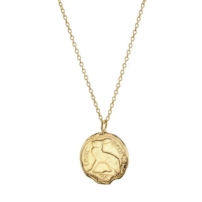 A Gold Vermeil 3 Pence Coin Necklace from Loinnir Jewellery, features a genuine casting of a Pre-Decimal Irish coin collection. The coin has been coated with 18ct gold over sterling silver to provide a high-quality and lustrous finish that glimmers in the light with every movement. This exceptional piece of jewelry is versatile and can be worn for everyday wear or to complement a formal outfit.