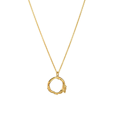 The Gold Twig Necklace, cast from a Gorse bush twig, features a delicate circular pendant. This modern Irish necklace makes a unique gift from Ireland